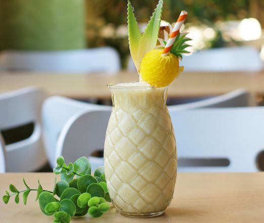 Refreshing tropical pineapple cocktail with fresh garnish served in a decorative glass indoors.
